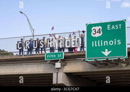 Burlington, Iowa, Stati Uniti. 26 agosto 2025. Gli attivisti politici del gruppo indivisibile dell'Iowa hanno tenuto segnali di "SCHIACCIAMENTO DEL GHIACCIO" su un cavalcavia autostradale per protestare contro la politica di applicazione dell'immigrazione degli Stati Uniti. Credito: Keith Turrill/Alamy Live News Foto Stock