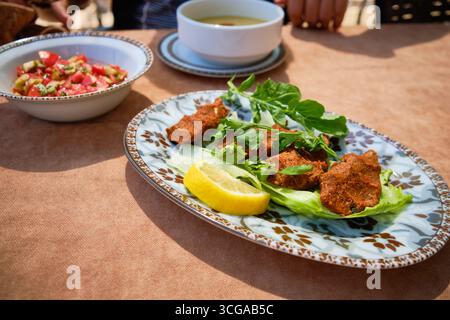 Tradizionale Cig Kofte turco servito con erbe fresche e limone Foto Stock