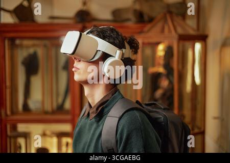 Giovane uomo caucasico sperimentare la realtà virtuale in ambiente museale Foto Stock