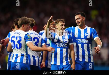 Brajan Gruda di Brighton e Hove Albion (secondo a destra) festeggia davanti ai tifosi in trasferta dopo che il suo compagno di squadra Olivier Boscagli ha segnato il primo gol ai lati durante la partita del secondo turno della Carabao Cup all'Hill Kassam Stadium di Oxford. Data foto: Mercoledì 27 agosto 2025. Foto Stock