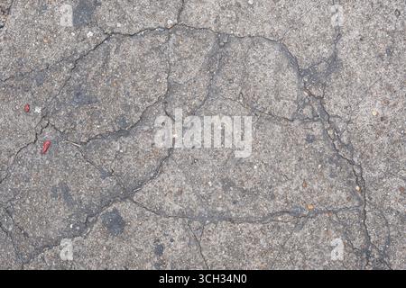 Vecchio sfondo grigio incrinato per pavimenti in cemento Foto Stock