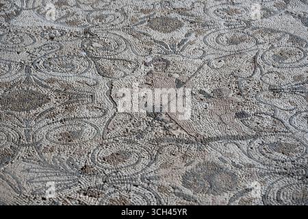 Antico pavimento a mosaico con intricati motivi geometrici e colori sbiaditi dalla Casa del Anfiteatro a Merida, Spagna Foto Stock
