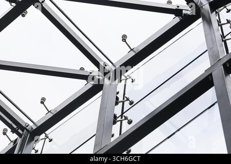 Moderna struttura in acciaio. Elemento di architettura industriale contro il cielo. Dettagli astratti della struttura urbana. Travi in metallo con geometria. Foto Stock