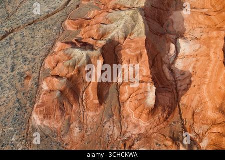 Splendida prospettiva aerea che cattura le vivaci sfumature e le intricate texture delle montagne rosse, mettendo in mostra il potere dell'arte della natura Foto Stock