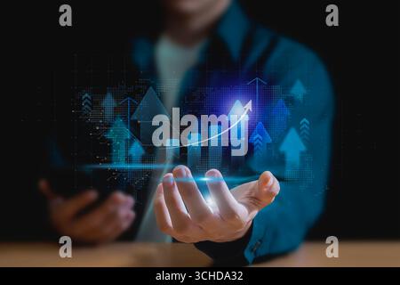 Sviluppo della strategia aziendale, uomo d'affari che detiene grafico di crescita aziendale, business, strategia di crescita e raggiungimento degli obiettivi con la freccia verso l'alto. Foto Stock