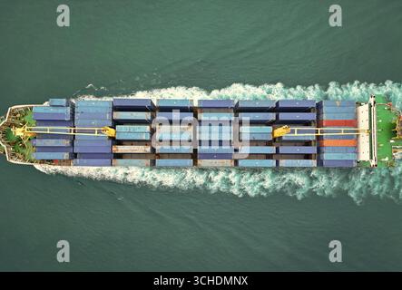 Logistica delle spedizioni. Spedizione commerciale. Nave da carico in mare, vista aerea. Enorme nave da carico. Container carico sulla nave. Vista aerea del carico Foto Stock