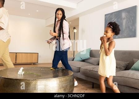 Madre e figlia afroamericane che si godono momenti giocosi a casa insieme Foto Stock