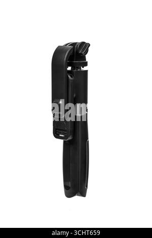 Un elegante mini treppiede ripiegato nero con supporto per telefono. Foto Stock