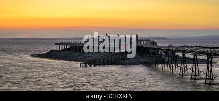 Tramonto al vecchio molo di Birnbeck, fatiscente, a Weston Super Mare, Somerset, Regno Unito, e la ristrutturazione è prevista per l'estate 2025-2027 Foto Stock