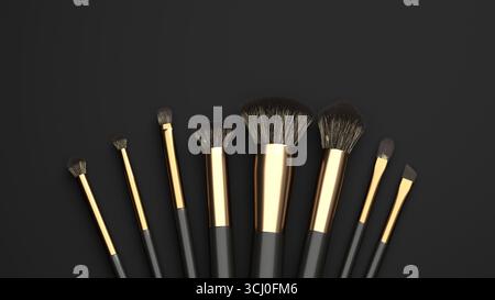 Vari pennelli per il trucco sono visualizzati su uno sfondo scuro, mostrando le loro diverse forme e dimensioni. Ogni spazzola presenta eleganti manici neri e oro Foto Stock