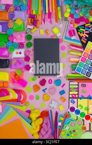 Ampia gamma di materiali d'arte, pennarelli, penne colorate e matite colorate, pennelli, vernici, carta dai colori vivaci. Bella disposizione piatta con spazio vuoto Foto Stock