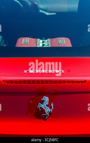 Close-up of the rear view of a red Ferrari with the iconic logo Foto Stock
