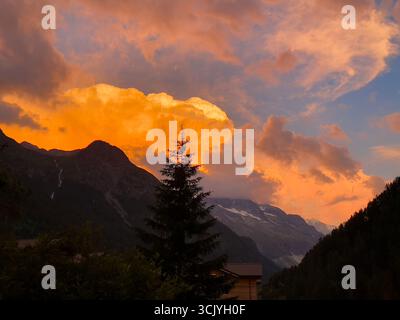 Thundercloud che si forma sulle Alpi svizzere al crepuscolo. Foto Stock