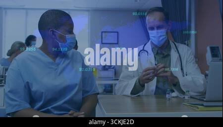 Prelievo del vaccino medico in camice da laboratorio utilizzando la siringa in stanza dell'ospedale con infermiere in scrub osservando Foto Stock