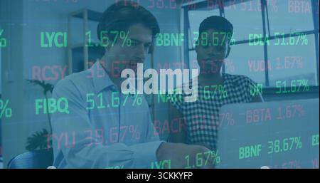 Collaborare con i colleghi nel business casual analizzando i numeri su notebook con sovrapposizione di codici mobili Foto Stock