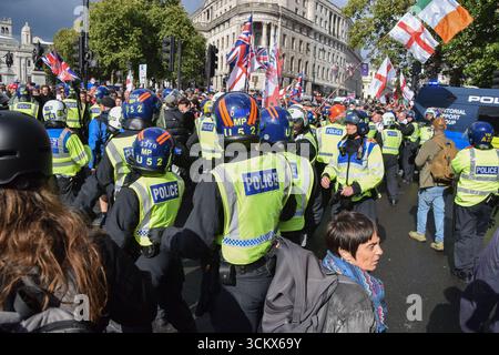 Londra, Regno Unito. 13 settembre 2025. La polizia in equipaggiamento antisommossa spinge indietro i manifestanti di destra mentre scoppia una serie di scontri contro il razzismo e l'antifascismo a Trafalgar Square. I manifestanti di estrema destra marciarono fino a Westminster per un raduno fuori Downing Street chiamato "Unite the Kingdom", mentre marciarono anche contro-manifestanti antifascisti. Crediti: Vuk Valcic/Alamy Live News Foto Stock