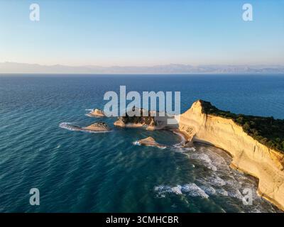 Una vista aerea da sogno e rossastra delle iconiche scogliere di argilla di Capo Drastis al tramonto sull'isola di Corfù, in Grecia Foto Stock