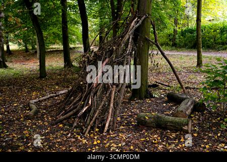 Rifugio fatto a mano fatto di rami nella foresta Foto Stock