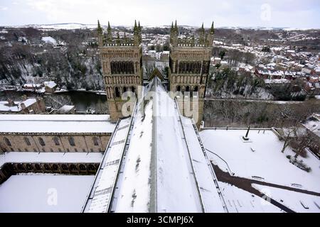 Le torri occidentali della cattedrale di Durham sorvegliano la città di Durham, coperta da una fitta coperta di neve Foto Stock