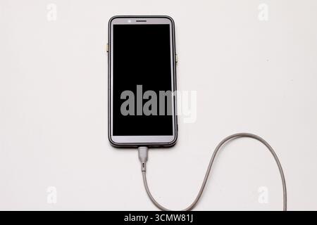Vista ravvicinata della batteria dello smartphone in carica. Foto Stock