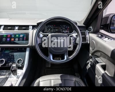 Derby, Regno Unito - 19 settembre 2025: Volante Range Rover, con l'iconico logo Range Rover, pulsanti multifunzione integrati Foto Stock