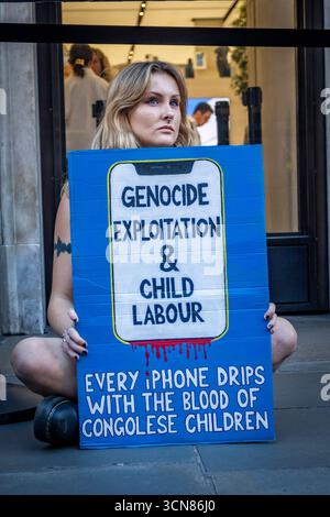 Gli attivisti hanno organizzato una protesta fuori dall'Apple Store in Regent Street, nel centro di Londra, il 17 settembre durante il lancio dell'iPhone 17. I manifestanti hanno tenuto manifesti che dichiaravano “iPhone 17 coperto di sangue”, accusando Apple di trarre profitto dalle miniere di cobalto in Congo legate al lavoro minorile e alle violazioni dei diritti umani. Le code dei clienti che tentavano di entrare nell'Apple Store di Regent Street sono state incontrate con canti, cartelloni e spettatori che si sono riuniti per assistere alla protesta. Foto Stock