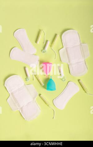 Vista dall'alto dei prodotti per la salute mestruale, tra cui tazze mestruali, tamponi e tamponi sanitari, promuovendo una vita sostenibile e la salute delle donne su a. Foto Stock