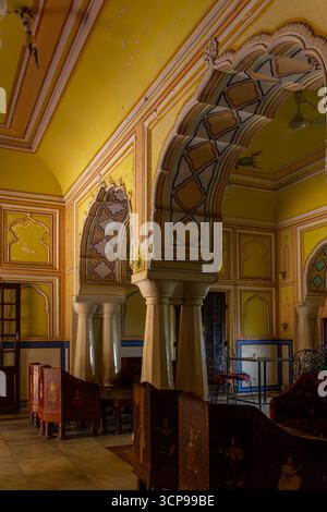 Vista interna della sala del Palazzo decorata con archi dipinti e mobili tradizionali Foto Stock