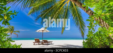 Spiaggia soleggiata con vista romantica, ombrellone. Tranquillo orizzonte marino con sabbia bianca e cielo soleggiato. Rilassanti palme lasciano una fantastica vacanza panoramica Foto Stock