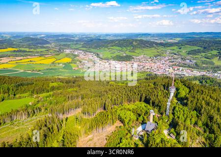 La vista aerea cattura la torre di osservazione di Svatobor, che si erge in alto sul lussureggiante paesaggio e la città di Susice annidata nella valle, mostrando la bellezza della natura e dell'architettura della Cechia. Foto Stock