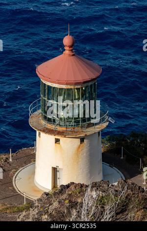 Una vista mozzafiato del faro di Makapu'u sulla costa orientale di Oahu, dove la ricca storia marittima delle Hawaii incontra le incontaminate scogliere oceaniche e l'oceano blu profondo Foto Stock