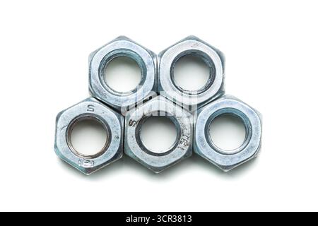 Dadi metallici disposti in una pila, che mostrano la loro forma esagonale e la superficie lucida Foto Stock