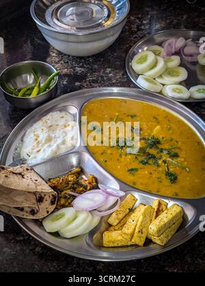 Tradizionale thali indiano con dal, roti, riso e verdure. Foto Stock