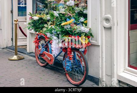 Pedala sui canali di Amsterdam con ponti panoramici e il centro storico della città, patrimonio dell'umanità dell'UNESCO Foto Stock