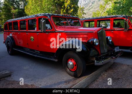 Autobus rossi del Glacier National Park parcheggiati per la notte al Lake McDonal Lodge. Affettuosamente noto come "Red Jammers", il modello White Motor Company Foto Stock