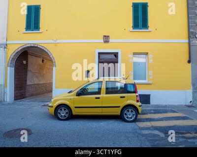 Canneto sul Oglio, Italia 22 settembre 2025 Fiat Panda 169 giallo brillante del 2003 è parcheggiata su una strada vicino ad un passaggio pedonale, accanto ad un voi Foto Stock