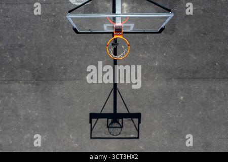Campo da pallacanestro con l'ombra del cestino a terra in vista aerea Foto Stock