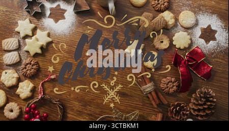 Buon Natale immagine testuale su biscotti e ingredienti da forno su un tavolo di legno Foto Stock