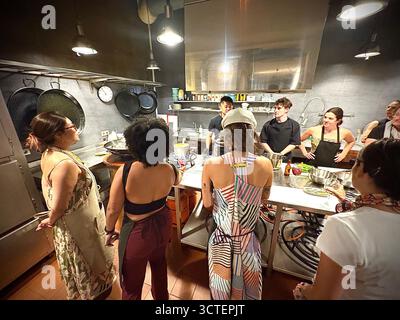 Lezione di cucina sulla paella di Barcellona, i partecipanti guardano l'istruttore dello chef che organizza attività di cucina e preparazione per la paella, Spagna, Europa Foto Stock