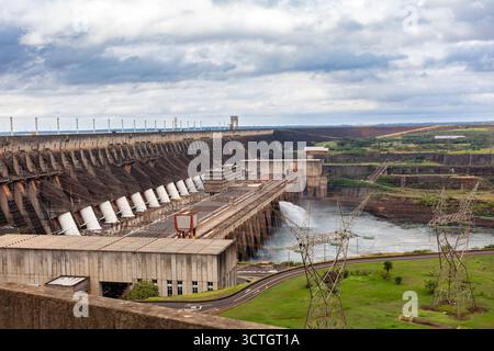 Itaipu Binacional, Brasile - 22 giugno 2025: Ampia vista della centrale idroelettrica di Itaipu e dell'imponente muro della diga sopra il canale del fiume Parana Foto Stock