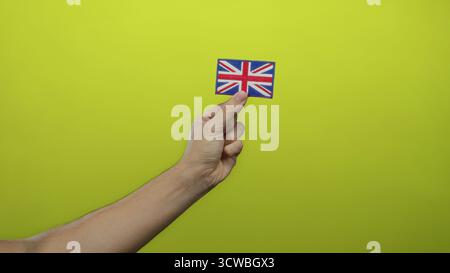 Uomo con bandiera della gran bretagna ricamata su sfondo giallo che mostra orgoglio nazionale con dettagli e semplicità Foto Stock