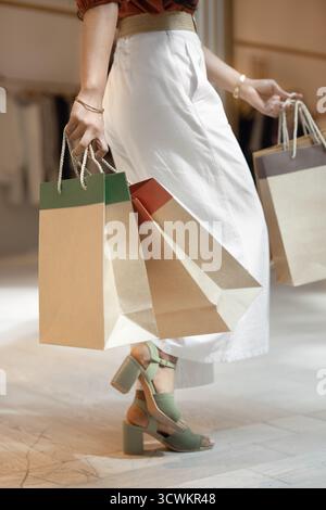 Foto ritagliata di un'elegante donna che cammina nel centro commerciale Foto Stock