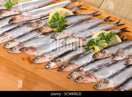 Acciughe europee salate con limone e prezzemolo Foto Stock