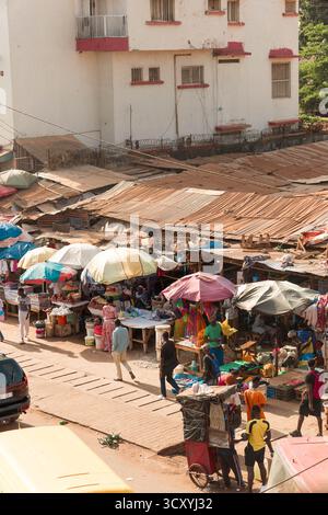 Traffico intenso e un vivace mercato marciapiede su un viale principale nella città di Bissau, Guinea-Bissau Foto Stock