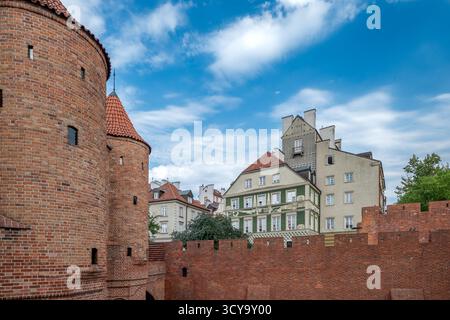 Le mura difensive della città vecchia di Varsavia. Pareti in mattoni, case cittadine sullo sfondo. La capitale della Polonia. Podwale Street. Il Barbican. Foto Stock