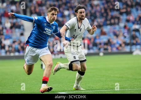 Glasgow, Regno Unito. 18 ottobre 2025. I Rangers FC hanno giocato con il Dundee United FC all'Ibrox Stadium di Glasgow in una partita di Scottish Premiership. Il punteggio finale è stato Rangers 2 - 2 Dundee United. Mikey Moore (R47) e William Ferry (D11) corrono per la palla. Crediti: Findlay/Alamy Live News Foto Stock