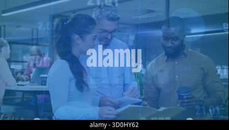 Collaborazione tra colleghi che esaminano leganti e tablet in un ufficio moderno, con tazze da caffè da asporto Foto Stock