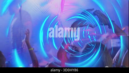 Abbina la forma del cuore alle mani al festival musicale, con i braccialetti LED per smartphone con raggi laser Foto Stock