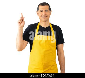 Età media al negoziante uomo che indossa il grembiule in piedi isolato su sfondo bianco con un grande sorriso sul volto, dispositivo di puntamento con la mano e le dita per il lato basso Foto Stock