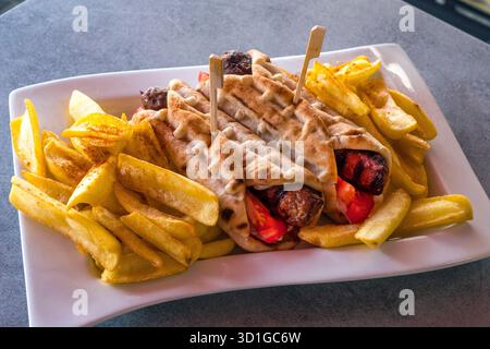 Gyro greco con carne e patatine fritte Foto Stock
